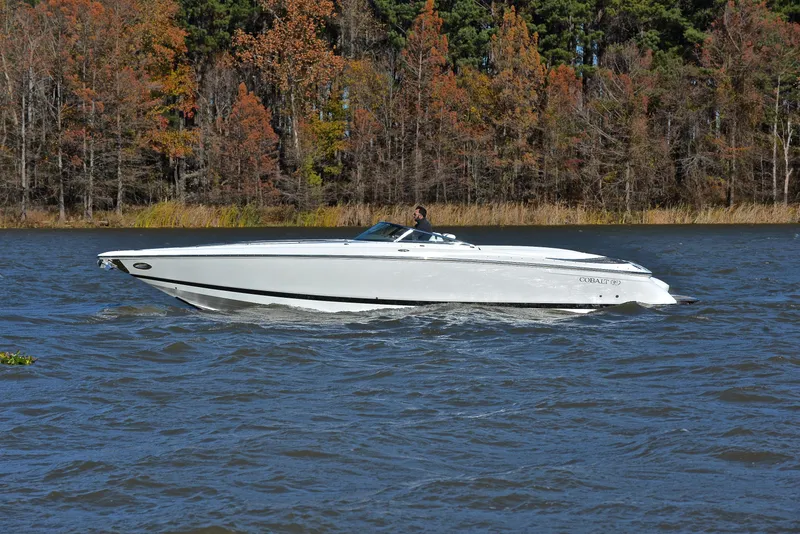 Slide: The Image of 2005 Cobalt 343 boat cruising on a lake with autumn trees in the background. - 10