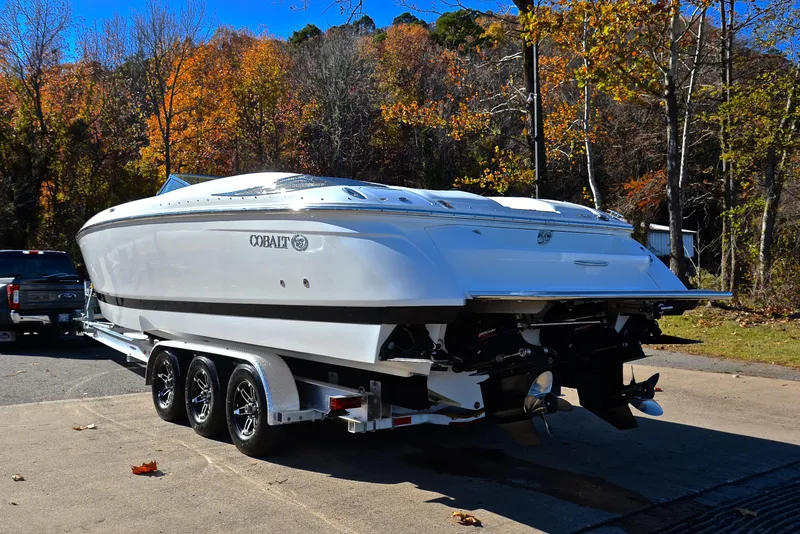 Slide: The Image of 2005 Cobalt 343 boat on trailer, surrounded by autumn trees. - 16