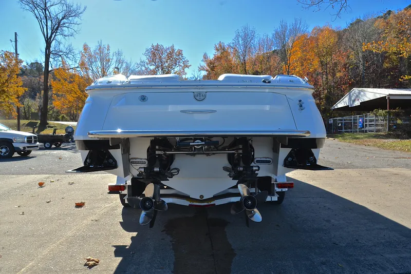 Slide: The Image of Rear view of a 2005 Cobalt 343 boat with dual engines, parked outdoors. - 17