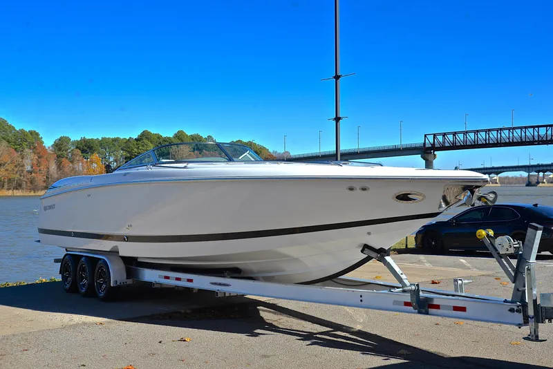Slide: The Image of 2005 Cobalt 343 boat on trailer by river, clear blue sky. - 20