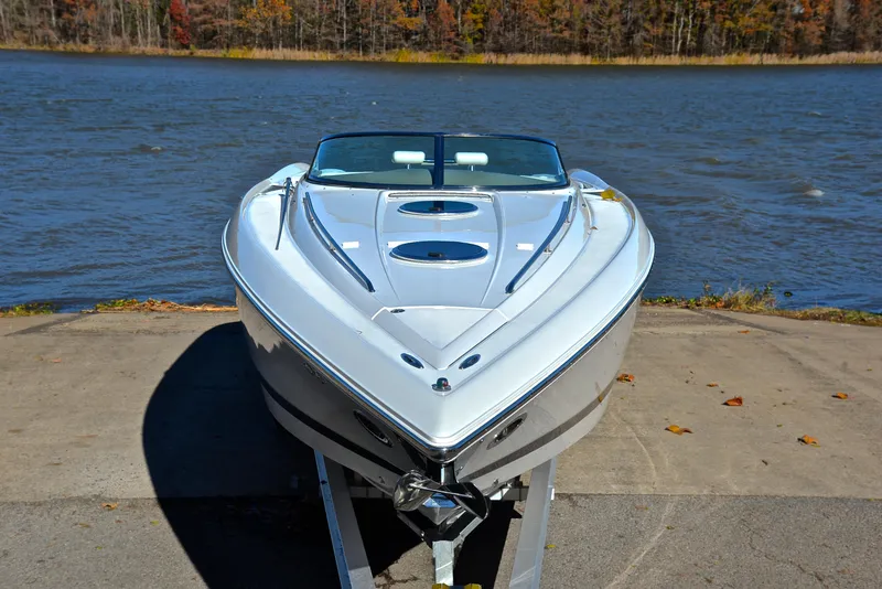 Slide: The Image of 2005 Cobalt 343 boat on trailer by a lake with autumn trees. - 21