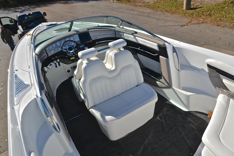 Slide: The Image of 2005 Cobalt 343 boat interior with white seating and sleek dashboard design. - 24