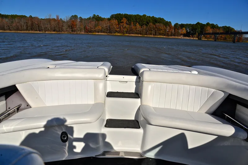 Slide: The Image of 2005 Cobalt 343 boat interior with white seating, lake view, and autumn trees. - 27