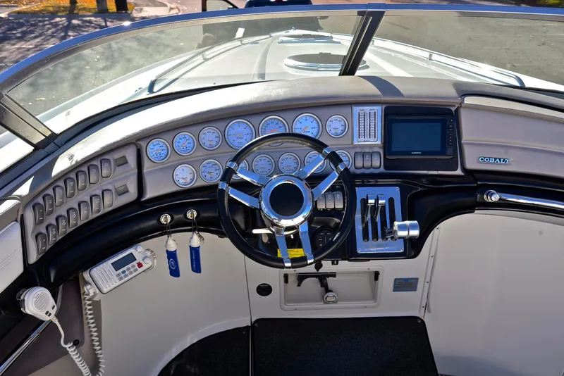 Slide: The Image of 2005 Cobalt 343 boat dashboard with steering wheel and control panel. - 28