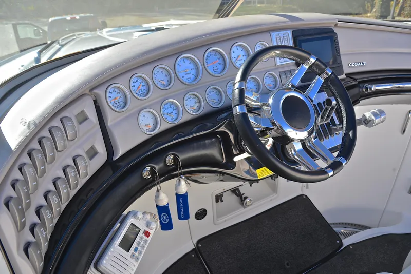 Slide: The Image of 2005 Cobalt 343 boat dashboard with gauges and steering wheel. - 29