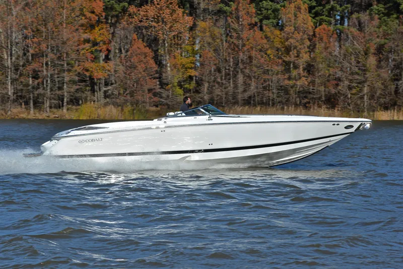 Slide: The Image of 2005 Cobalt 343 speedboat cruising on a lake with autumn trees in the background. - 3