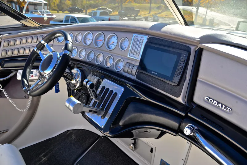 Slide: The Image of 2005 Cobalt 343 boat dashboard with steering wheel and control panel. - 30