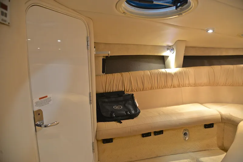 Slide: The Image of Interior of 2005 Cobalt 343 boat with beige seating and a black bag. - 32