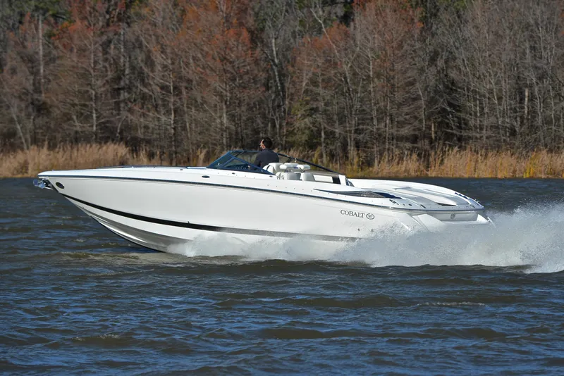 Slide: The Image of 2005 Cobalt 343 speedboat cruising on a lake with forested background. - 4