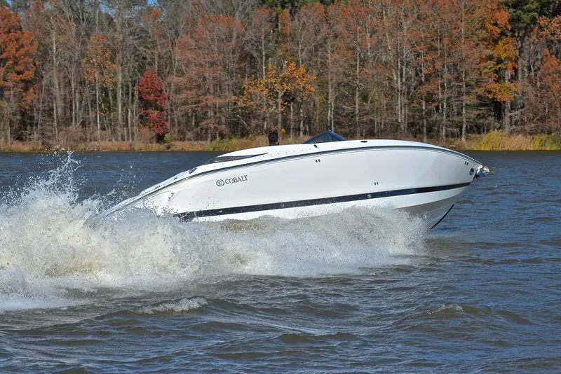 Slide: The Image of 2005 Cobalt 343 speedboat cruising on a lake with autumn trees in the background. - 5