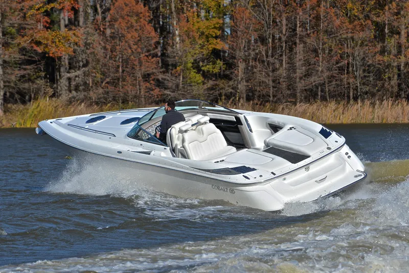 Slide: The Image of 2005 Cobalt 343 speedboat cruising on a lake with autumn trees in the background. - 6