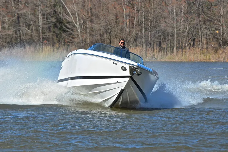 Slide: The Image of Man driving 2005 Cobalt 343 speedboat on a lake, creating splashes. - 7