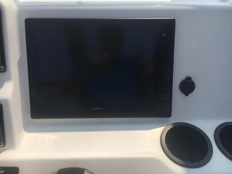 Slide: The Image of Dashboard of 2015 Boston Whaler 210 Montauk with Garmin display and cup holders. - 10