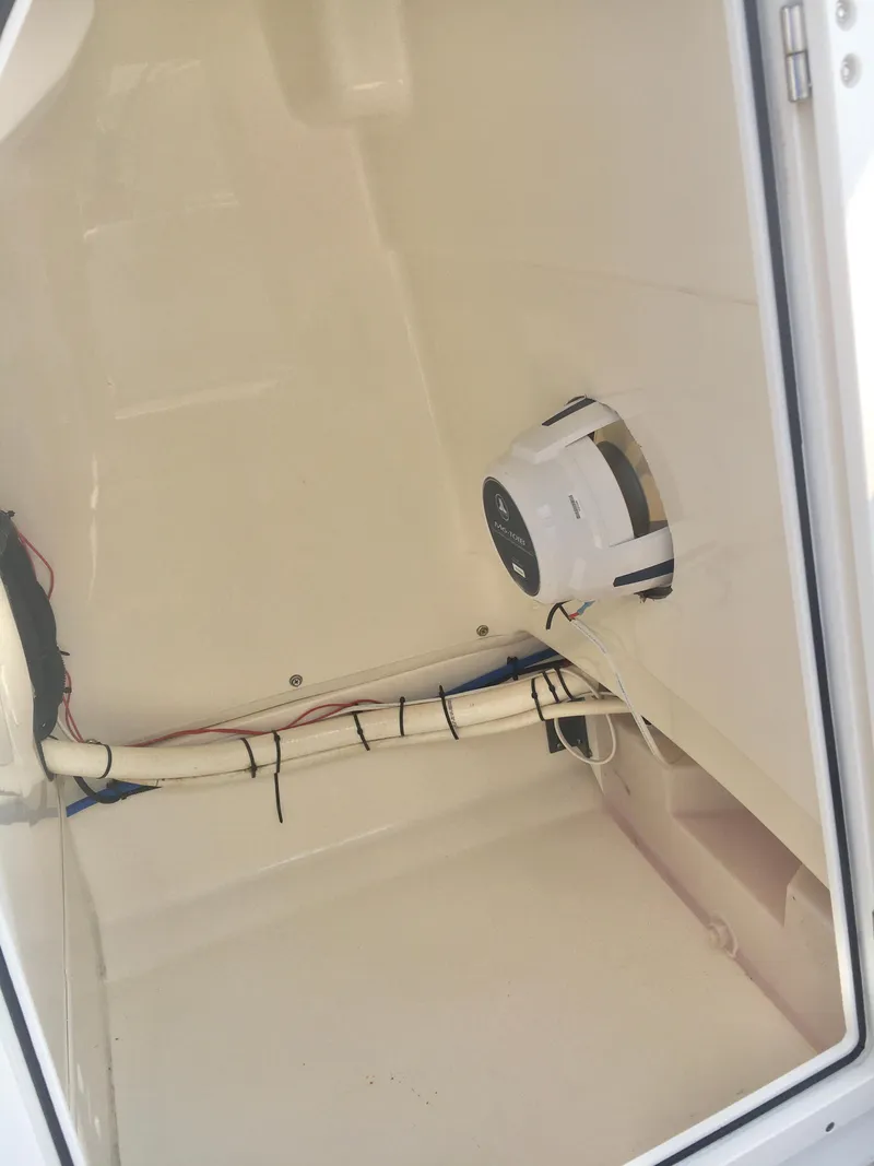 Slide: The Image of 2015 Boston Whaler 210 Montauk interior compartment with wiring and speaker. - 11