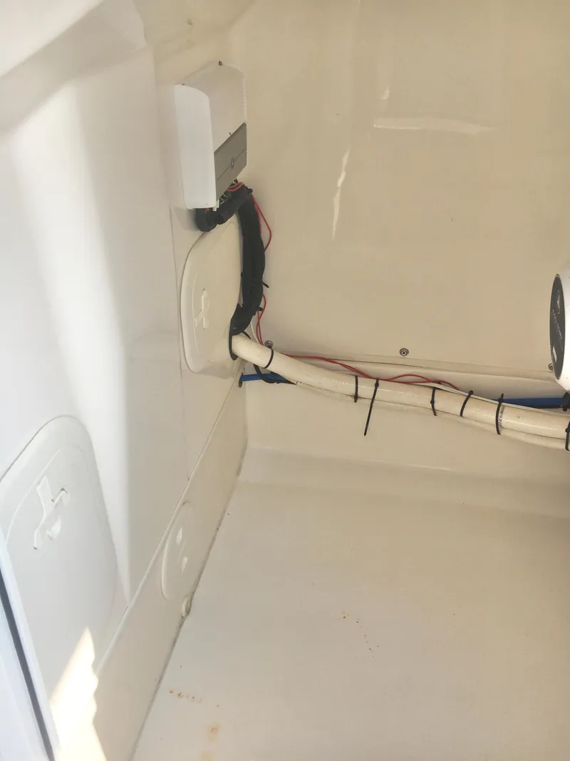 Slide: The Image of Interior view of a 2015 Boston Whaler 210 Montauk boat showing wiring and components. - 12