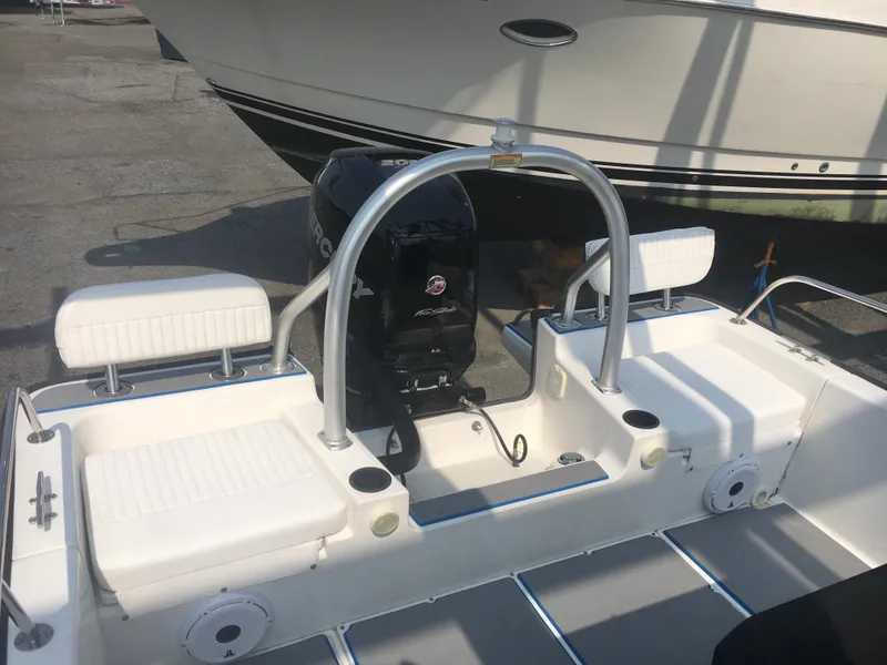 Slide: The Image of 2015 Boston Whaler 210 Montauk boat interior with seating and motor. - 14