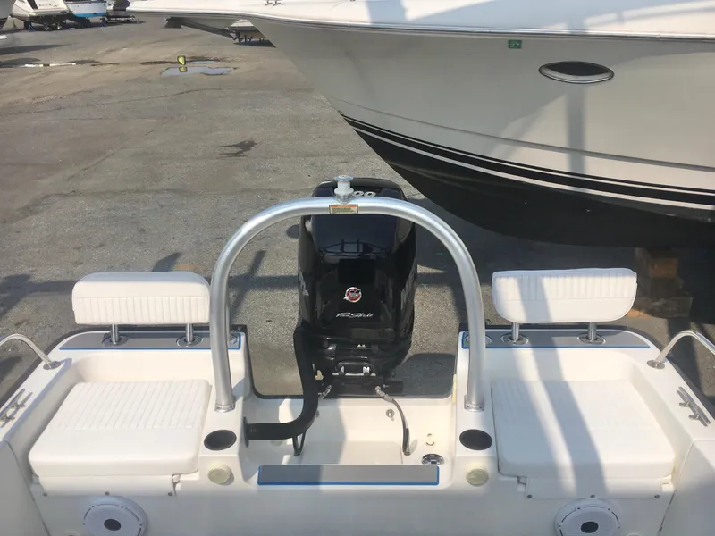 Slide: The Image of 2015 Boston Whaler 210 Montauk boat with Mercury engine, docked on a sunny day. - 15