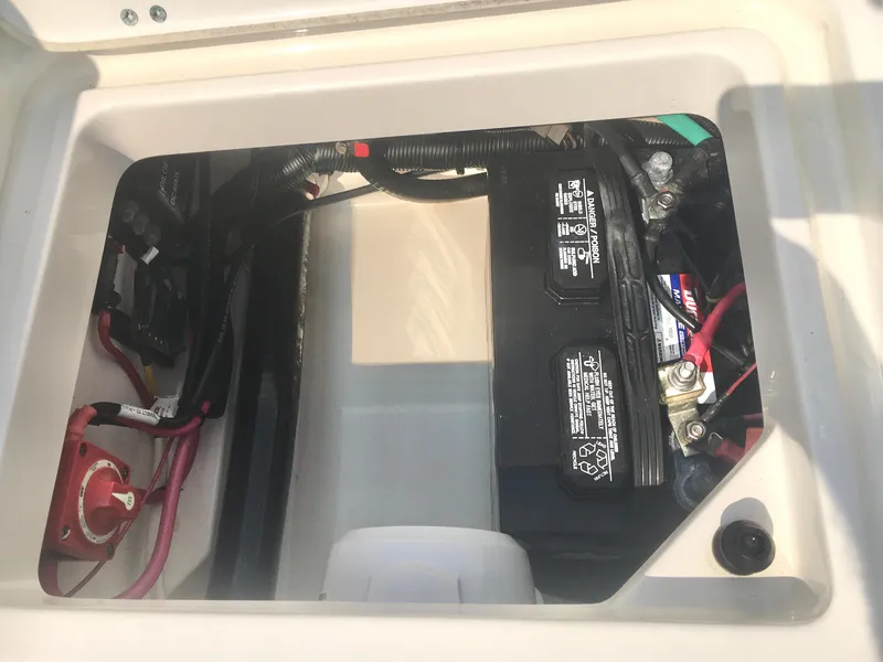 Slide: The Image of Battery compartment of a 2015 Boston Whaler 210 Montauk boat, showing wiring and connections. - 16