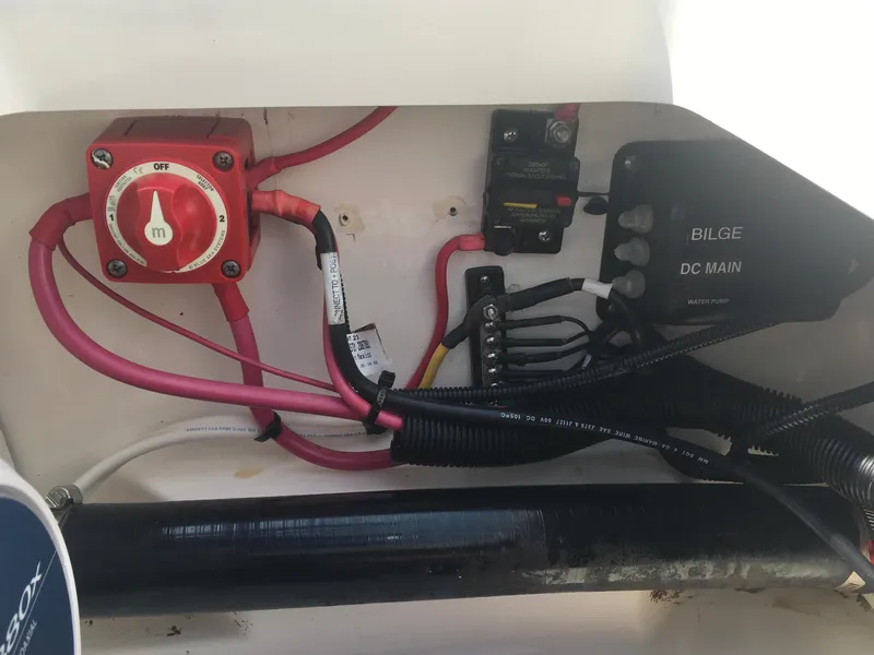 Slide: The Image of Electrical panel of a 2015 Boston Whaler 210 Montauk boat, featuring wiring and switches. - 18