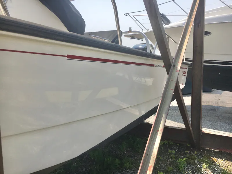 Slide: The Image of 2015 Boston Whaler 210 Montauk boat on a trailer, side view. - 2