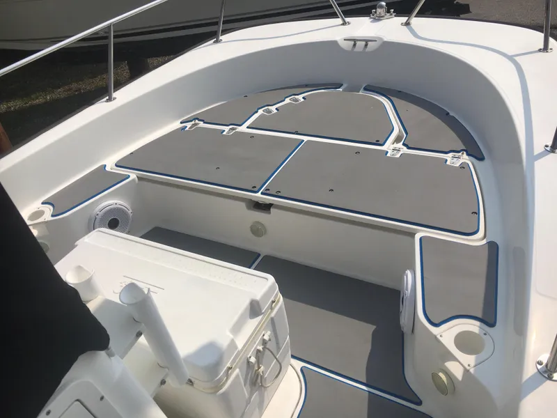 Slide: The Image of 2015 Boston Whaler 210 Montauk boat interior with seating and storage compartments. - 5