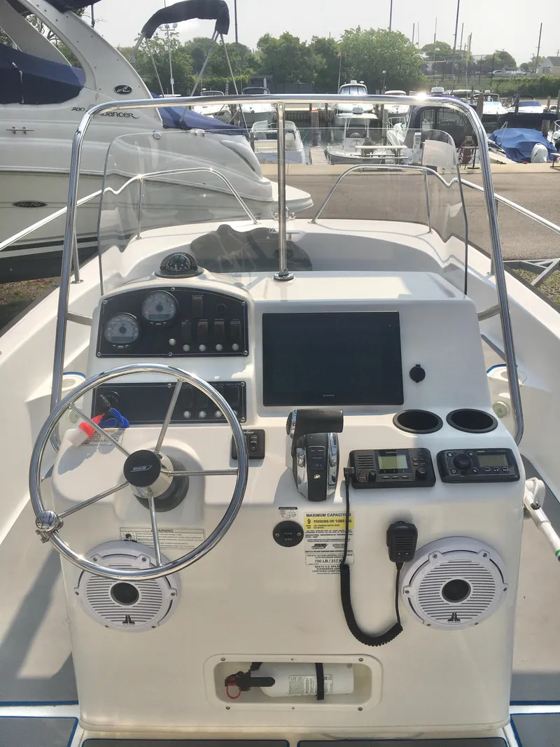 Slide: The Image of 2015 Boston Whaler 210 Montauk boat console with steering wheel and navigation equipment. - 6
