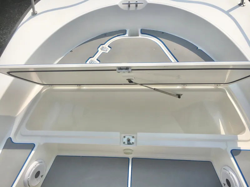 Slide: The Image of 2015 Boston Whaler 210 Montauk boat storage compartment open, showcasing spacious interior. - 7