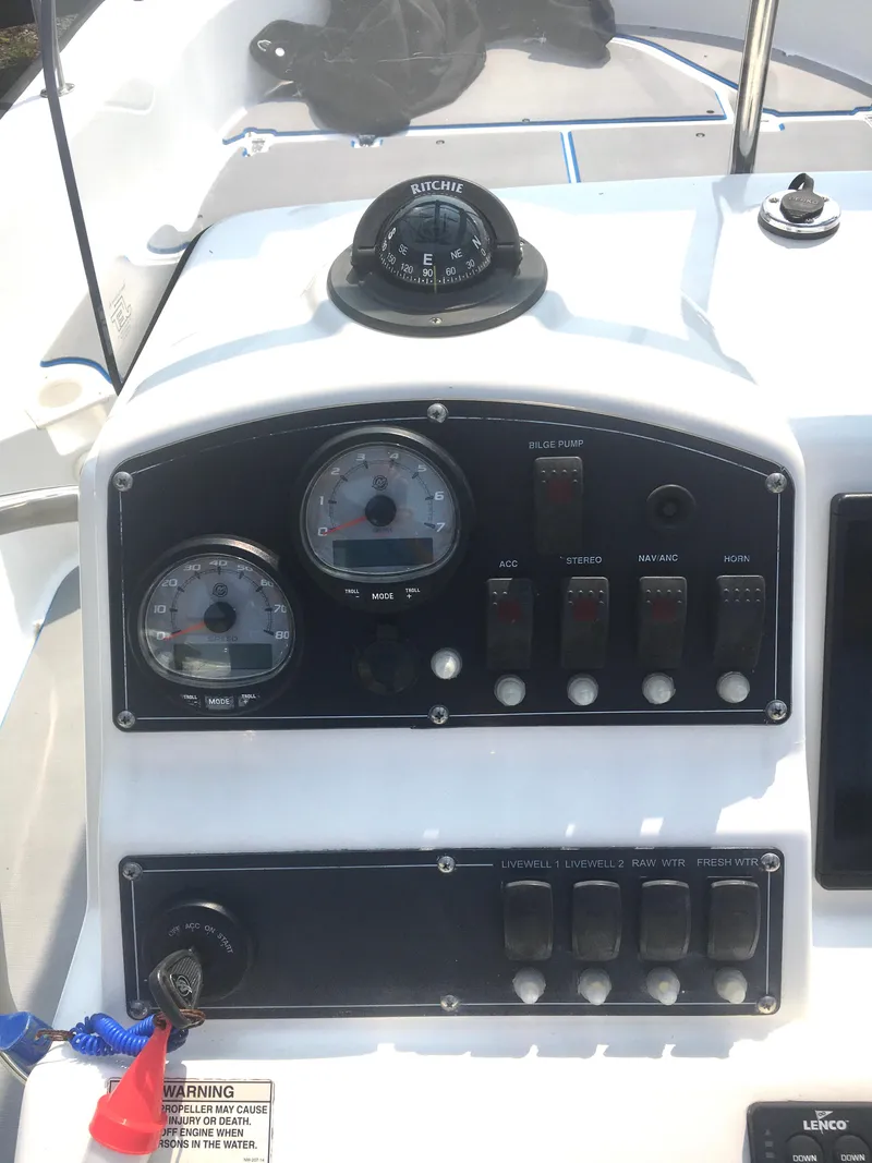 Slide: The Image of Dashboard of a 2015 Boston Whaler 210 Montauk boat with gauges and controls. - 8