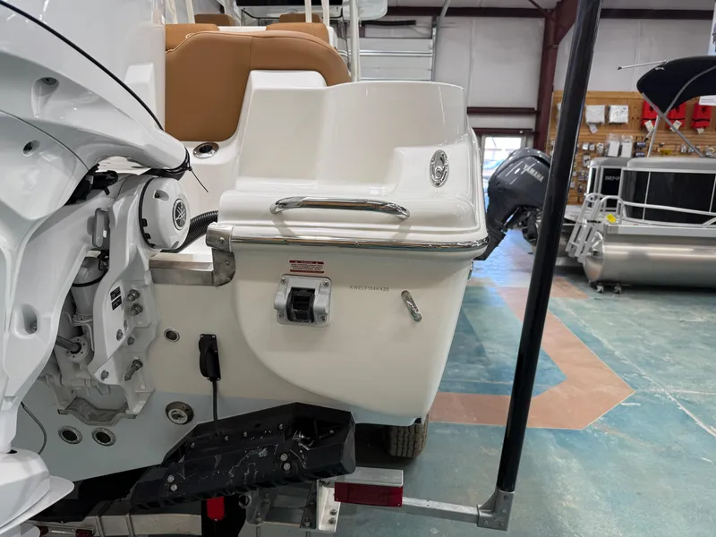 Slide: The Image of 2025 Key West 291FS boat in showroom, showcasing rear design and motor details. - 10