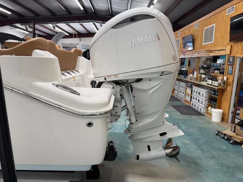 Slide: The Image of 2025 Key West 291FS boat with Yamaha outboard motor in showroom. - 11