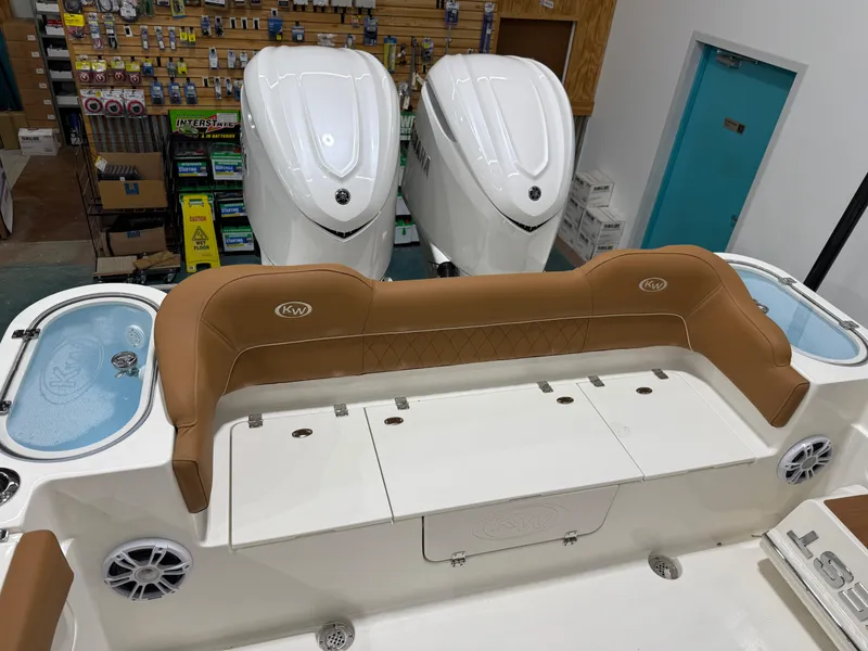 Slide: The Image of 2025 Key West 291FS boat interior with tan seating and dual engines. - 12