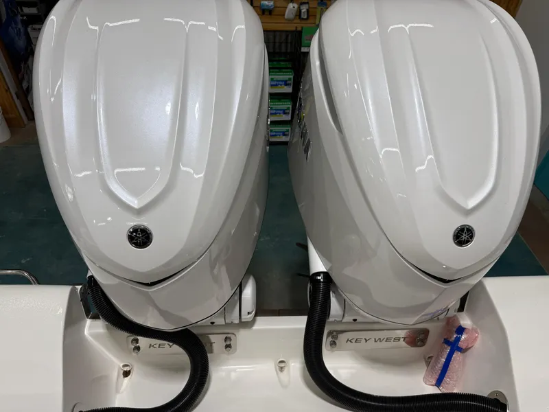 Slide: The Image of 2025 Key West 291FS boat with dual Yamaha outboard engines. - 13