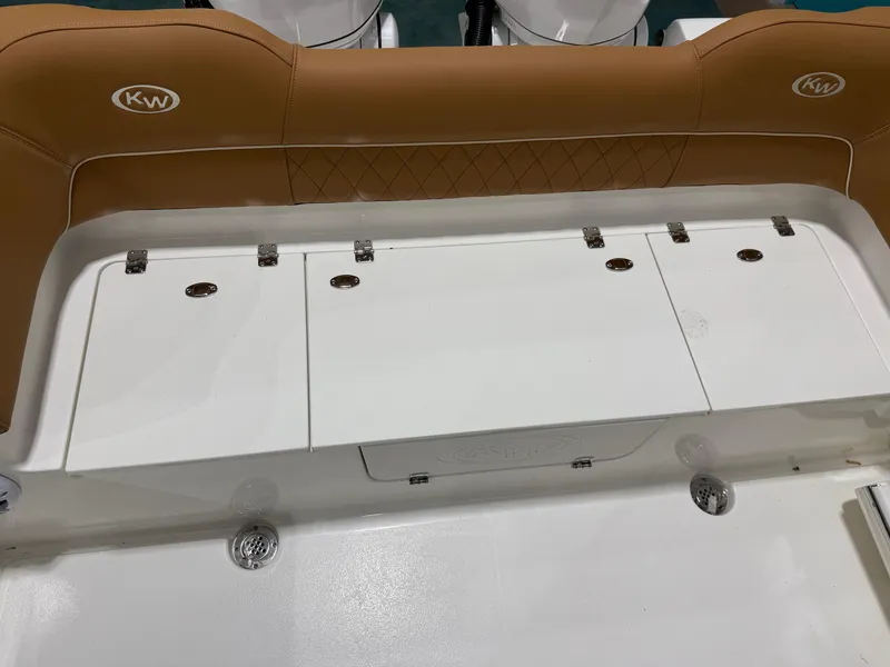 Slide: The Image of 2025 Key West 291FS boat interior with tan seating and storage compartments. - 16