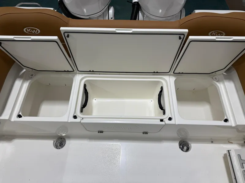Slide: The Image of 2025 Key West 291FS boat storage compartments with open lids, showcasing interior space. - 17