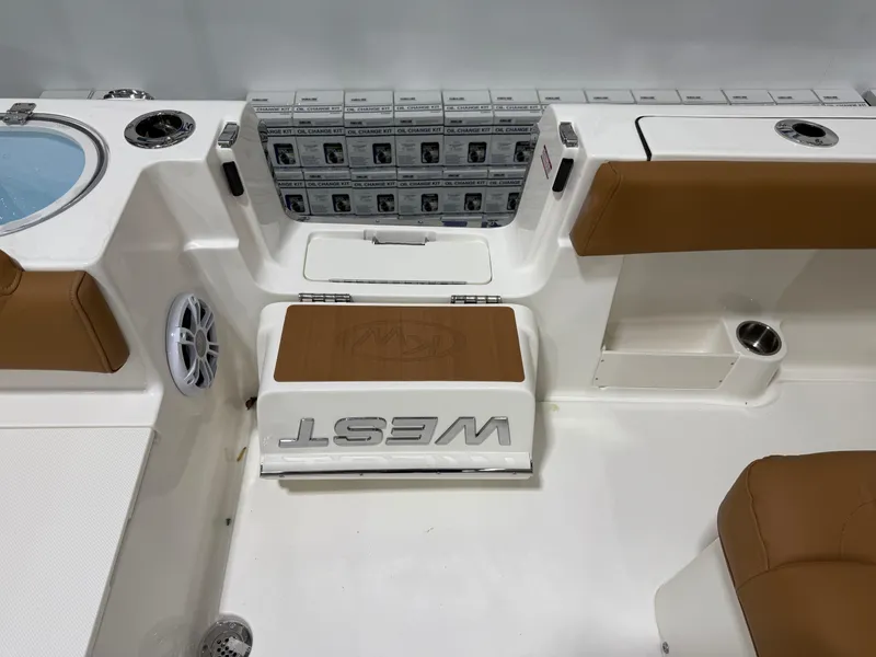 Slide: The Image of 2025 Key West 291FS boat interior with tan seating and storage compartments. - 19
