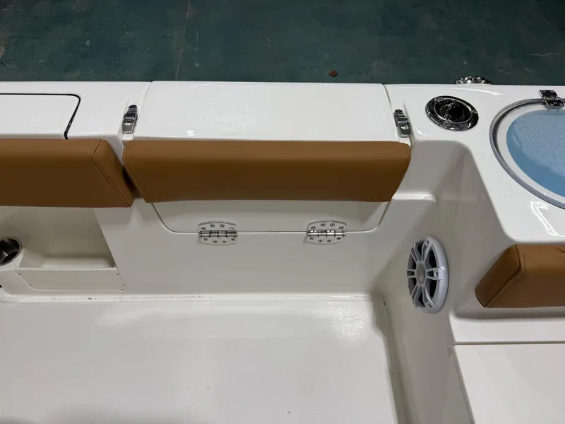 Slide: The Image of 2025 Key West 291FS boat interior with tan seating and speaker. - 20