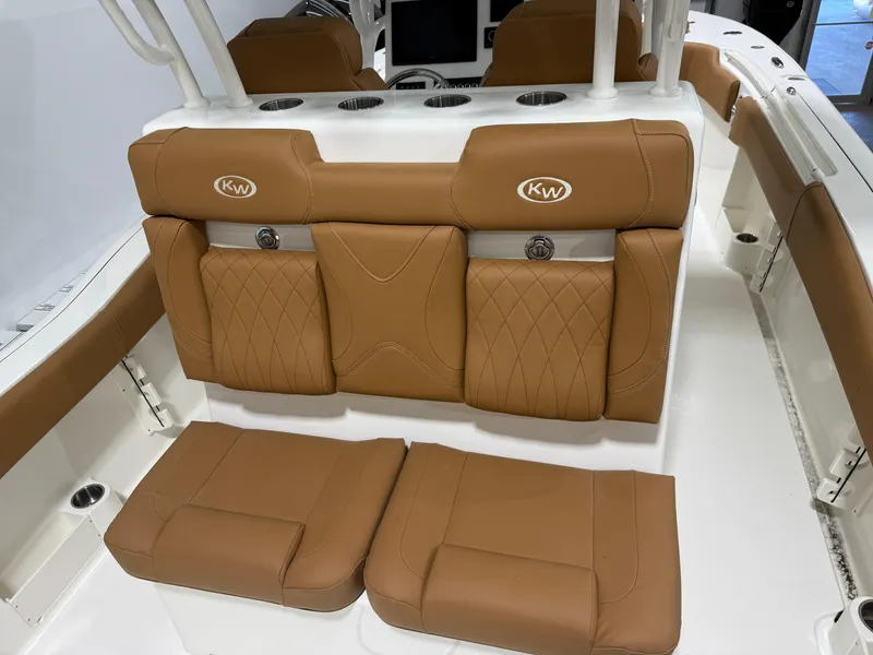 Slide: The Image of 2025 Key West 291FS boat interior with tan leather seating and cup holders. - 21