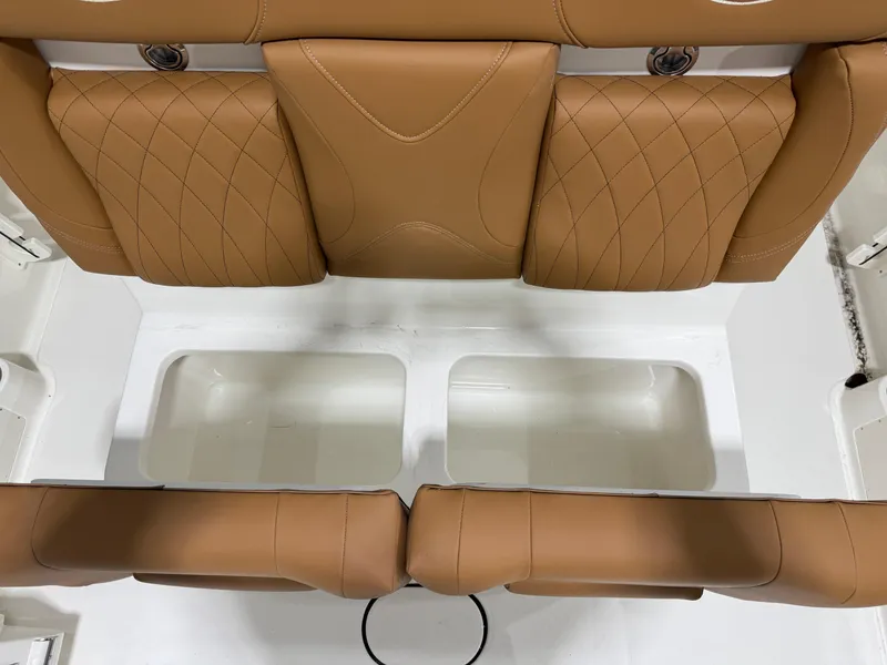 Slide: The Image of 2025 Key West 291FS boat interior with tan leather seating and storage compartments. - 22