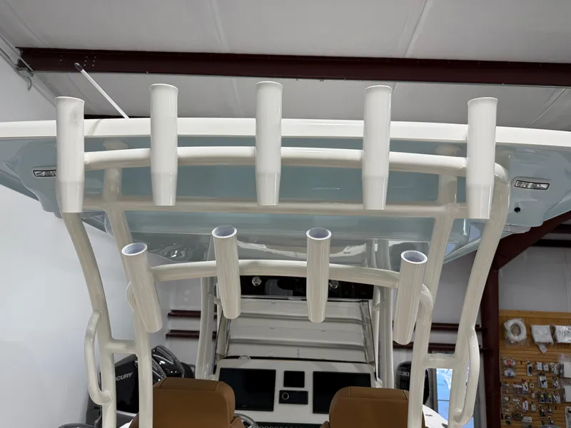 Slide: The Image of 2025 Key West 291FS boat with rod holders in a showroom. - 24