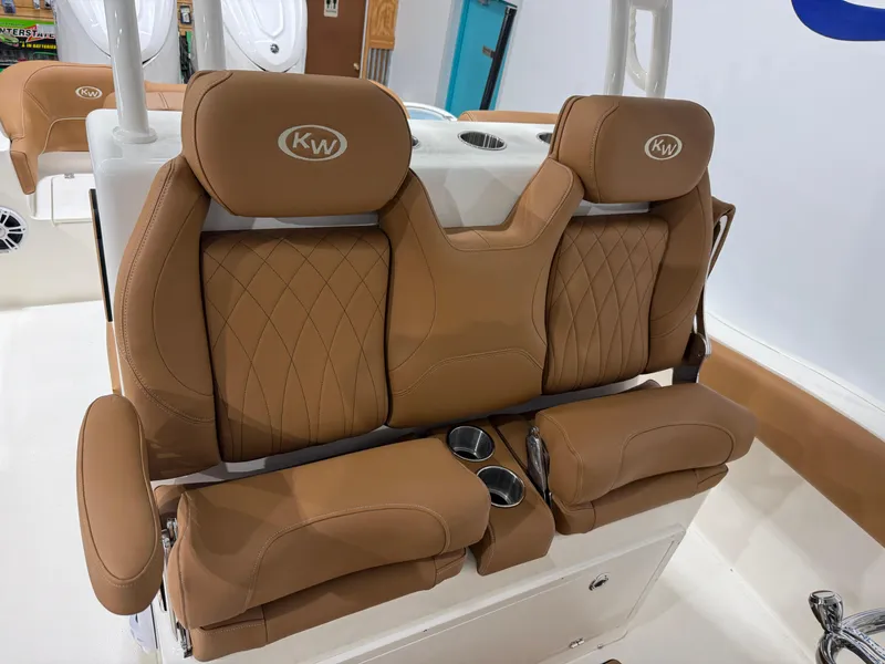 Slide: The Image of 2025 Key West 291FS boat seats with tan leather and cup holders. - 25
