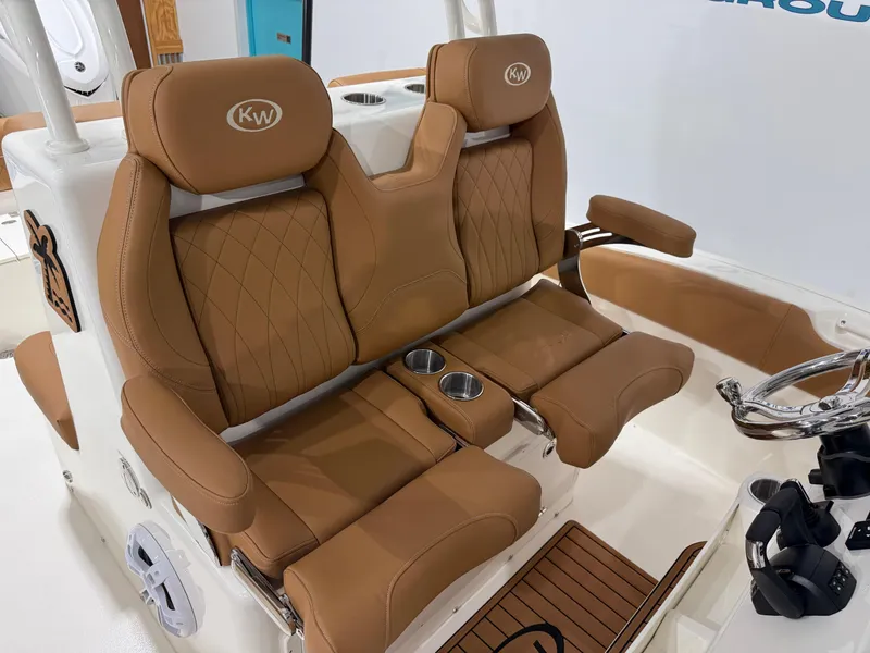 Slide: The Image of 2025 Key West 291FS boat seats with tan leather and cup holders. - 26