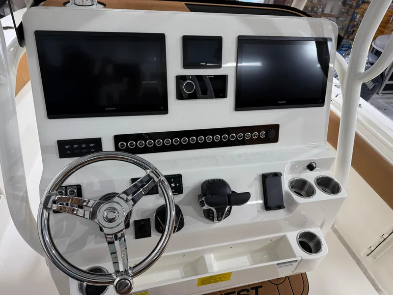 Slide: The Image of 2025 Key West 291FS boat dashboard with dual screens and modern controls. - 28