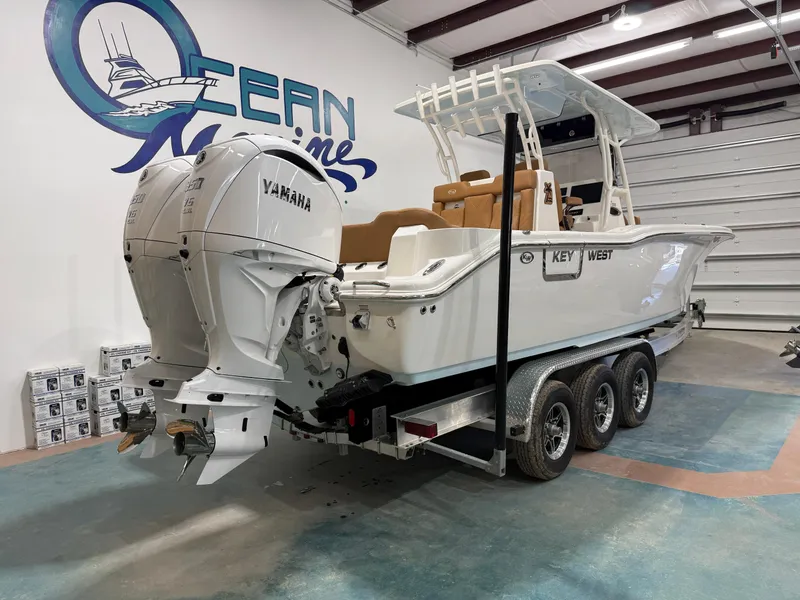 Slide: The Image of 2025 Key West 291FS boat with twin Yamaha engines on a trailer in a showroom. - 3