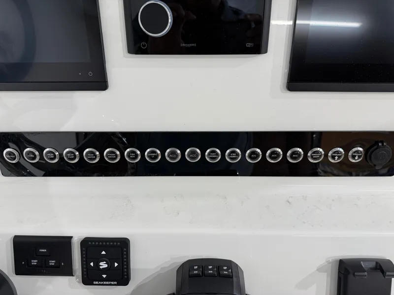 Slide: The Image of Control panel of 2025 Key West 291FS boat with various switches and displays. - 33