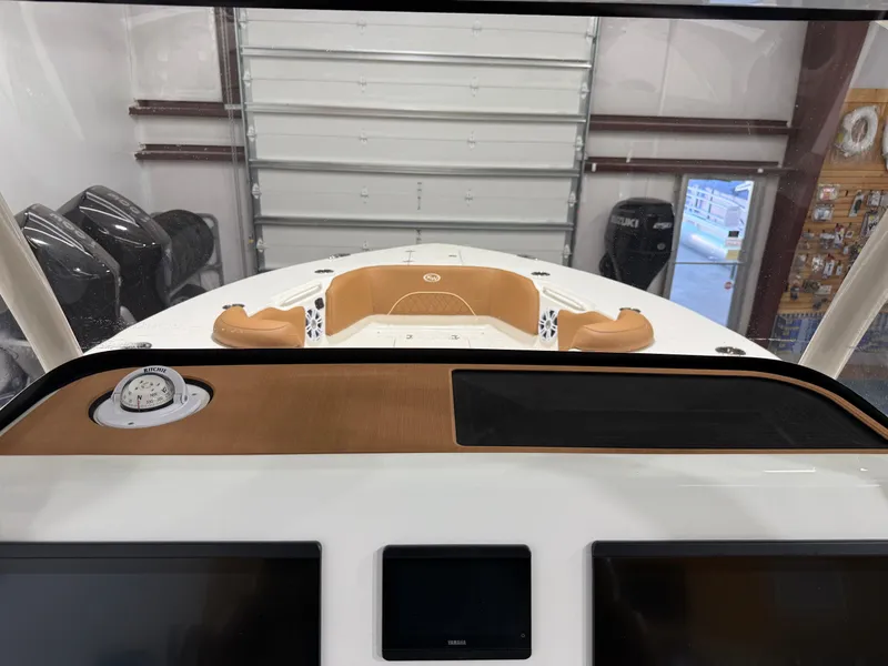 Slide: The Image of 2025 Key West 291FS boat interior with dashboard and compass in a garage setting. - 35