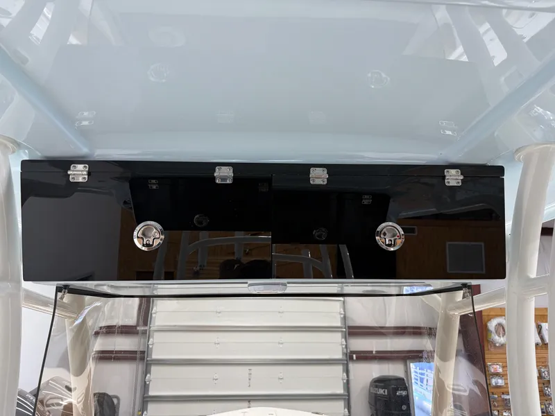 Slide: The Image of 2025 Key West 291FS boat console with sleek black storage compartments. - 36