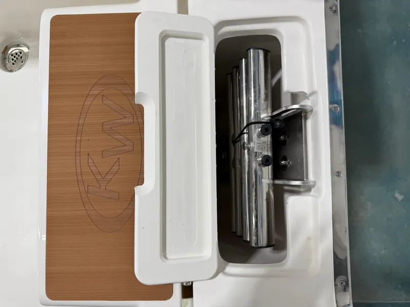 Slide: The Image of Key West 291FS 2025 boat compartment with KW logo and metal components. - 41
