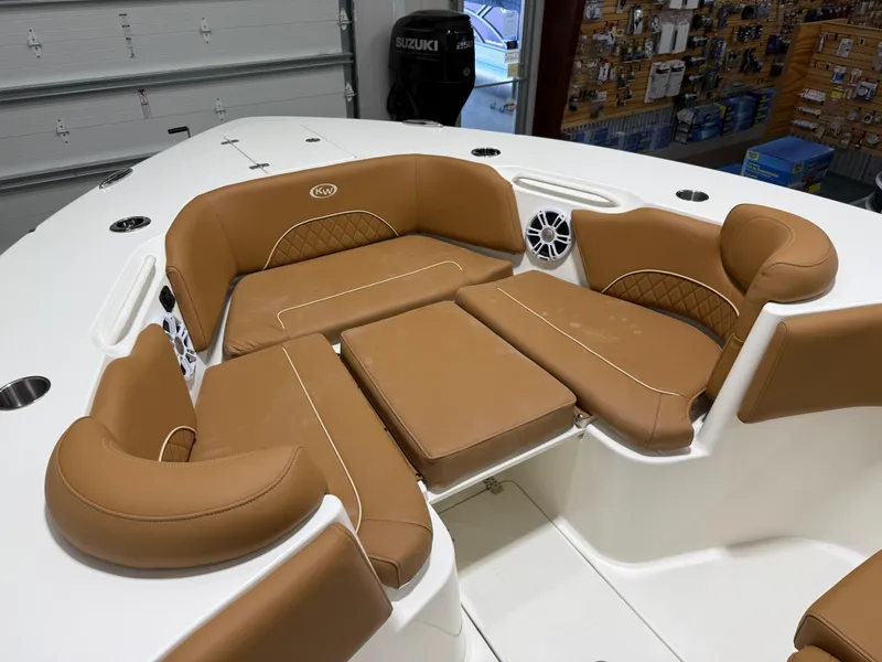 Slide: The Image of 2025 Key West 291FS boat interior with tan cushioned seating and white accents. - 43
