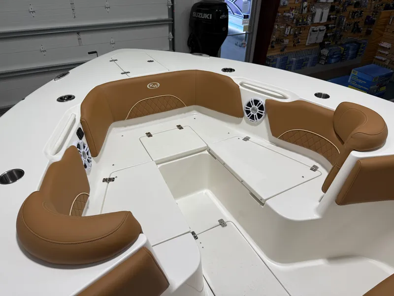 Slide: The Image of 2025 Key West 291FS boat interior with tan seating and storage compartments. - 47