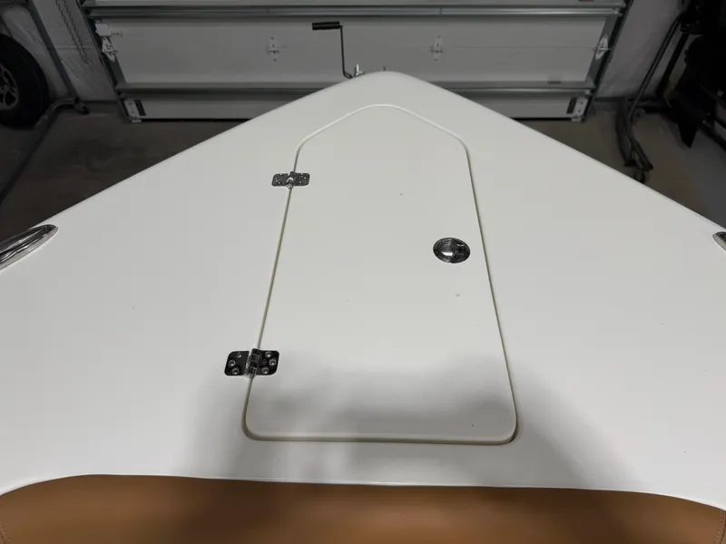 Slide: The Image of 2025 Key West 291FS boat deck with storage hatch in a garage. - 49